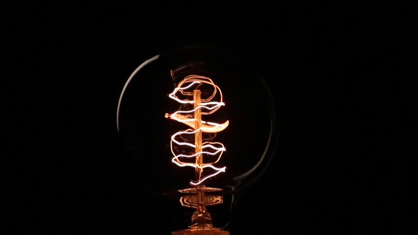 Light bulb turning on and off on black background | HDFootageStock.com