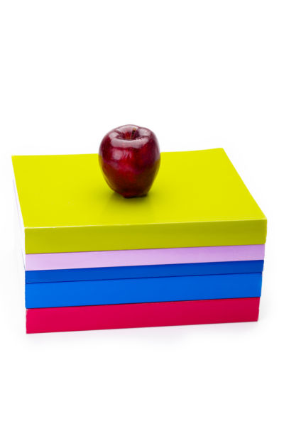 Colourful stack of books with apple on top - stock photo free