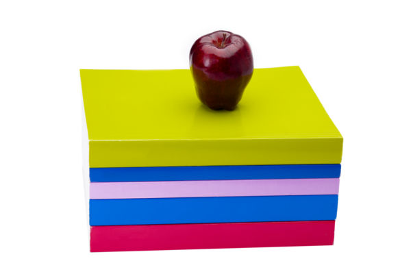 Apple on top of a stack of books - stock photo free