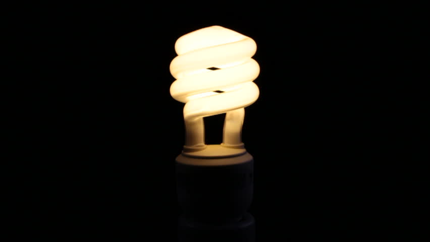 Energy Saving Light Bulb On Black Background Stock Footage Video ...