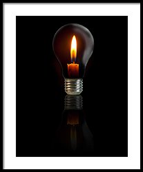 Candle On Light Bulb On Black Background Photograph by Thatchakon ...